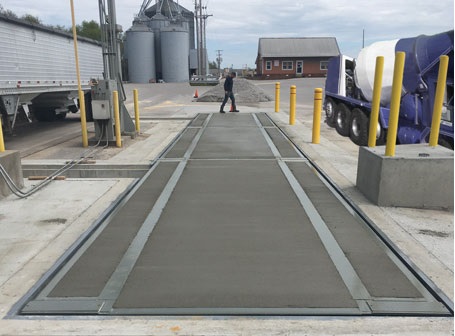 Weighbridge calibration service provider inspecting industrial weighbridge